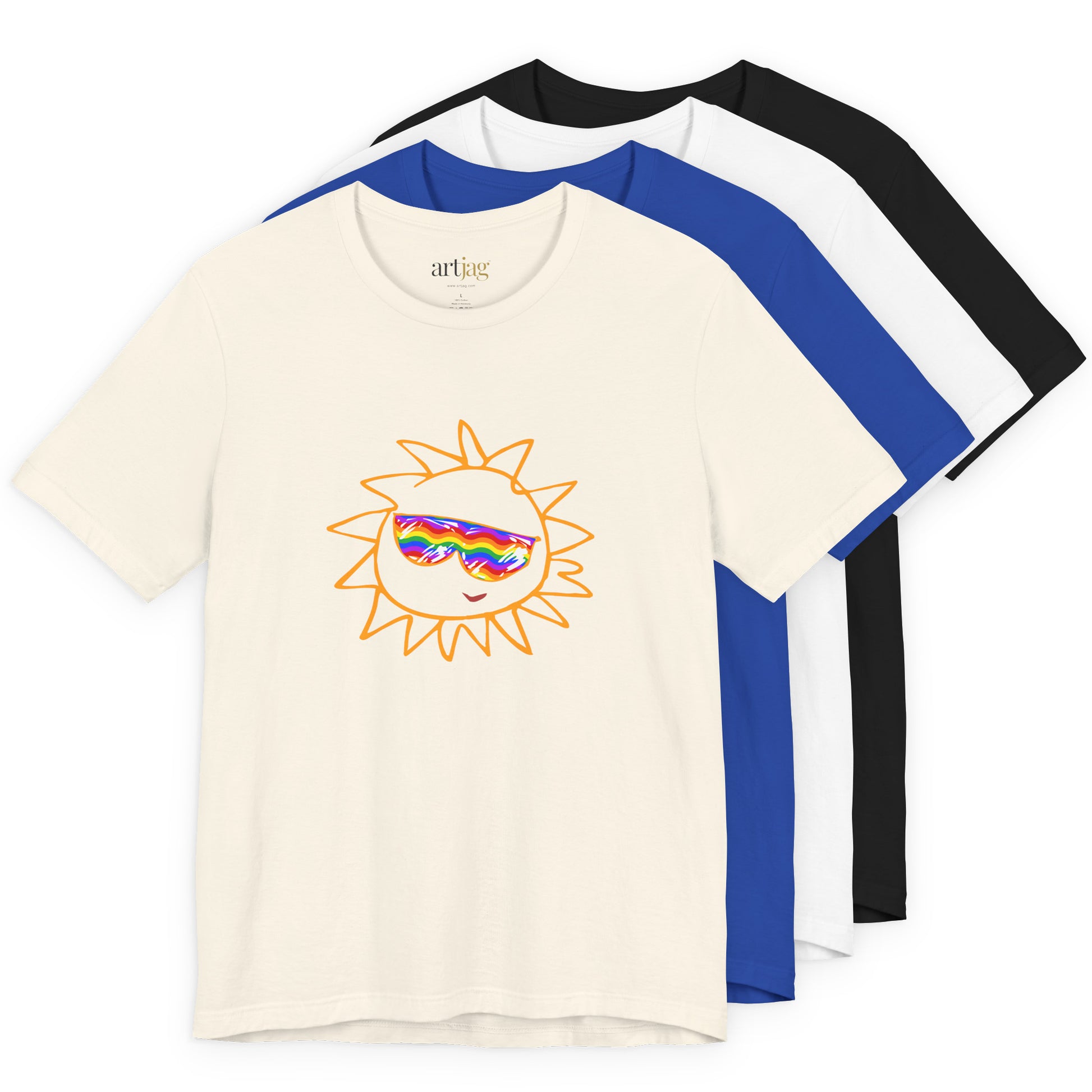 Three short-sleeve crewneck t-shirts layered together on a white background: a cream shirt in front with a rainbow sun graphic wearing blue sunglasses, a black shirt in the middle, and a white shirt in the back. The inner neck label reads 'artjag'.