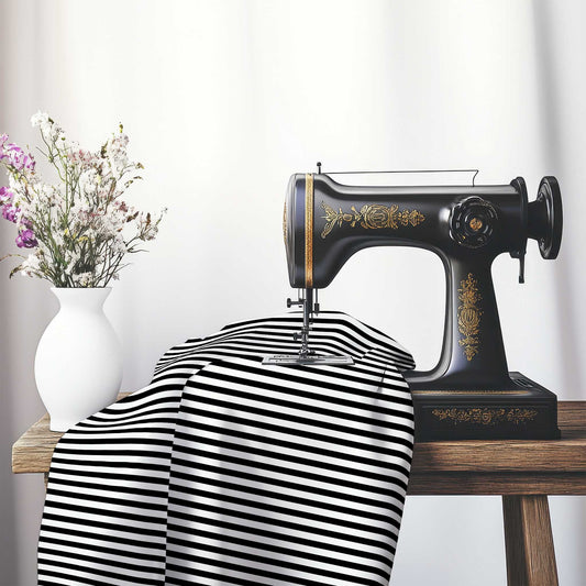 White Spun Polyester Fabric with Thin Black Bars, FASP-1010-241, on an antique sewing machine sitting on a desk with vase of beautiful flowers.