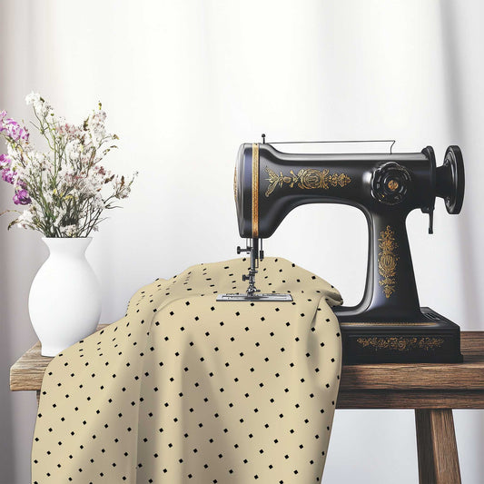 Spun Polyester Fabric with Black Diamonds on Tan , FASP-1014-101, on an antique sewing machine sitting on a desk with vase of beautiful flowers.