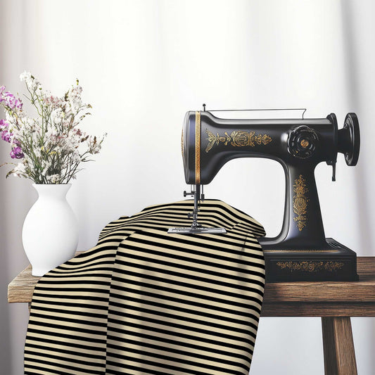 Spun Polyester Fabric with Thin Black Bars on Tan, FASP-1014-241, on an antique sewing machine sitting on a desk with vase of beautiful flowers.