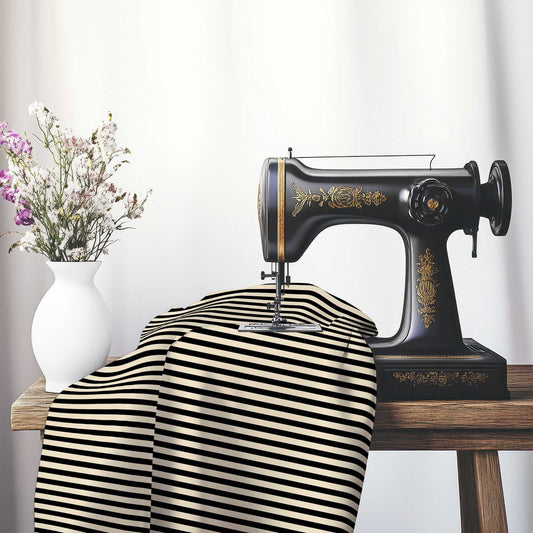 Spun Polyester Fabric with Thin Black Bars on Beige, FASP-1015-241, on an antique sewing machine sitting on a desk with vase of beautiful flowers.