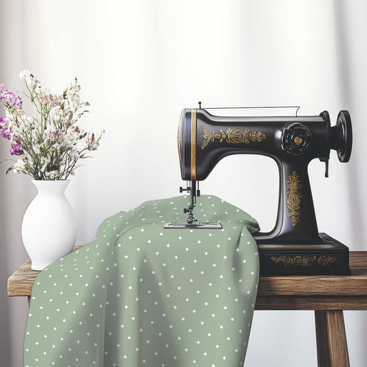 Spun Polyester Fabric with White Diamonds on Green, FASP-1052-102, on an antique sewing machine sitting on a desk with vase of beautiful flowers.