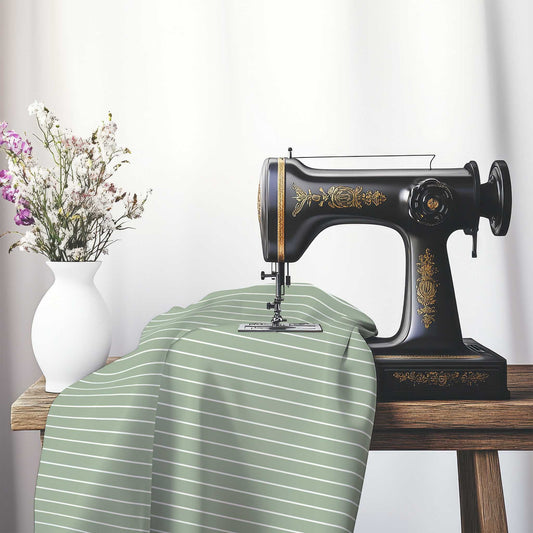 Spun Polyester Fabric with Fine White Stripes on Green, FASP-1052-152, on an antique sewing machine sitting on a desk with vase of beautiful flowers.