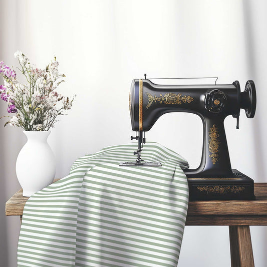 White Spun Polyester Fabric with Thin Green Bars, FASP-1052-241, on an antique sewing machine sitting on a desk with vase of beautiful flowers.