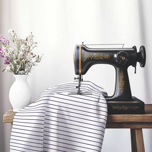White Spun Polyester Fabric with Fine Purple Stripes, FASP-1143-151, on an antique sewing machine sitting on a desk with vase of beautiful flowers.