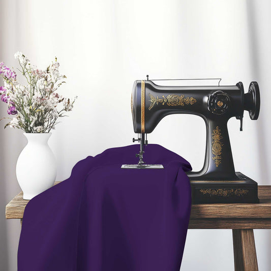 Purple Spun Polyester Fabric, FASP-1143-999, on an antique sewing machine sitting on a desk with vase of beautiful flowers.