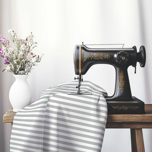 White Spun Polyester Fabric with Grey Bars, FASP-1203-051, on an antique sewing machine sitting on a desk with vase of beautiful flowers.