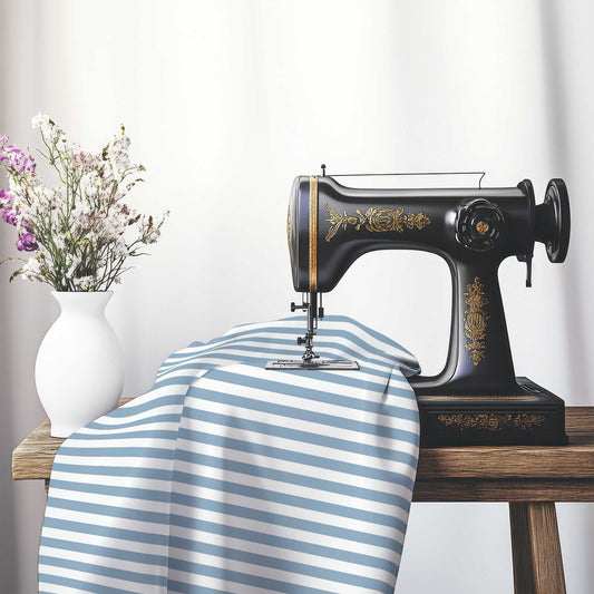 White Spun Polyester Fabric with Blue Bars, FASP-1231-051, on an antique sewing machine sitting on a desk with vase of beautiful flowers.