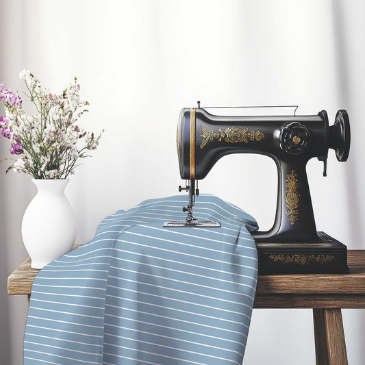 Spun Polyester Fabric with Fine White Stripes on Blue, FASP-1231-152, on an antique sewing machine sitting on a desk with vase of beautiful flowers.