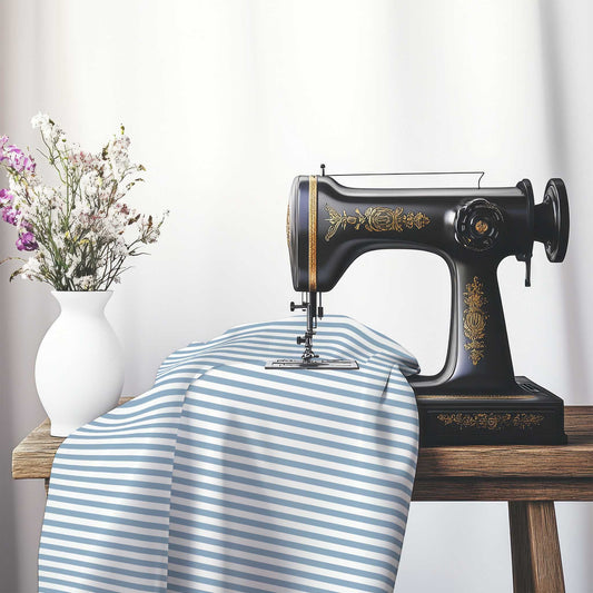 White Spun Polyester Fabric with Thin Blue Bars, FASP-1231-241, on an antique sewing machine sitting on a desk with vase of beautiful flowers.