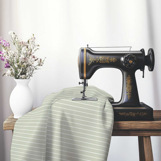 Spun Polyester Fabric with Fine White Stripes on Pale Green, FASP-1241-152, on an antique sewing machine sitting on a desk with vase of beautiful flowers.