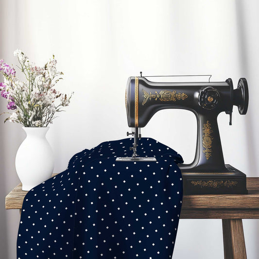 Spun Polyester Fabric with Off-white Diamonds on Navy Blue, FASP-1271-102, on an antique sewing machine sitting on a desk with vase of beautiful flowers.