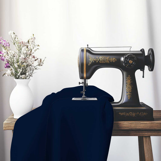 Navy Blue Spun Polyester Fabric, FASP-1271-999, on an antique sewing machine sitting on a desk with vase of beautiful flowers.