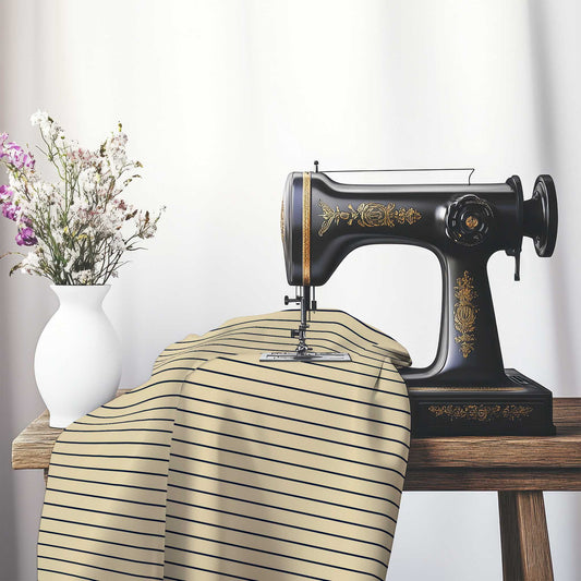Canvas Fabric with Fine Navy Blue Stripes on Tan, FASP-1274-151, on an antique sewing machine sitting on a desk with vase of beautiful flowers.