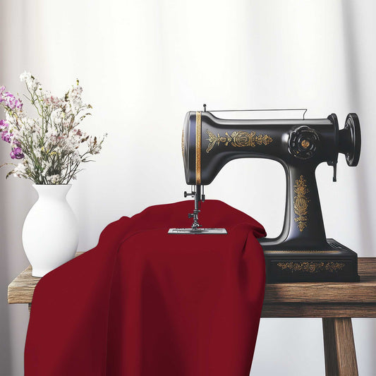 Burgundy Red Spun Polyester Fabric, FASP-1281-999, on an antique sewing machine sitting on a desk with vase of beautiful flowers.
