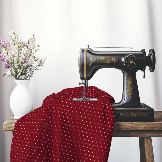 Spun Polyester Fabric with Fine Tan Diamonds on Burgundy Red, FASP-1284-112, on an antique sewing machine sitting on a desk with vase of beautiful flowers.