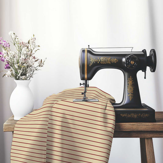 Spun Polyester Fabric with Fine Burgundy Red Stripes on Tan, FASP-1284-151, on an antique sewing machine sitting on a desk with vase of beautiful flowers.