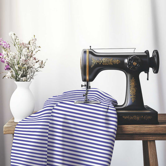 White Spun Polyester Fabric with Thin Purple Bars, FASP-1300-241, on an antique sewing machine sitting on a desk with vase of beautiful flowers.