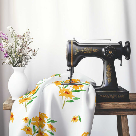 Printed Fabric with Handpainted Yellow-Orange Watercolor Floral, FASP-1314, on an antique sewing machine sitting on a desk with vase of beautiful flowers.