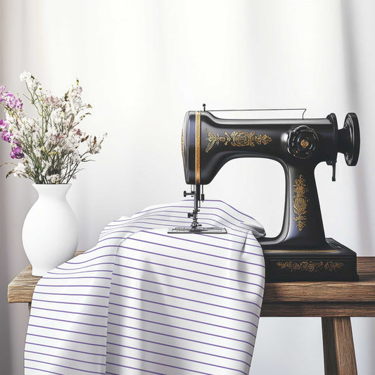 White Spun Polyester Fabric with Fine Purple Stripes, FASP-1320-151, on an antique sewing machine sitting on a desk with vase of beautiful flowers.