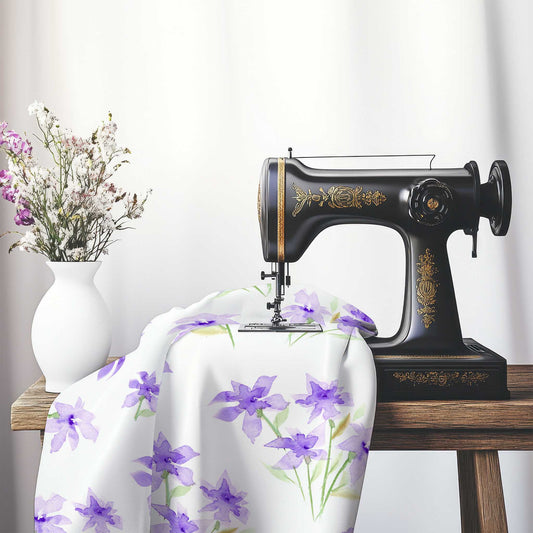 Printed Fabric with Handpainted Purple Watercolor Floral, FASP-1324, on an antique sewing machine sitting on a desk with vase of beautiful flowers.