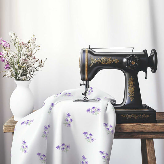 Printed Fabric with Handpainted Purple Watercolor Floral Pattern, FASP-1325, on an antique sewing machine sitting on a desk with vase of beautiful flowers.