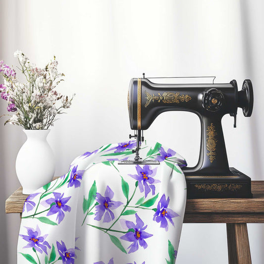 Printed Fabric with Handpainted Purple Watercolor Floral, FASP-1354, on an antique sewing machine sitting on a desk with vase of beautiful flowers.