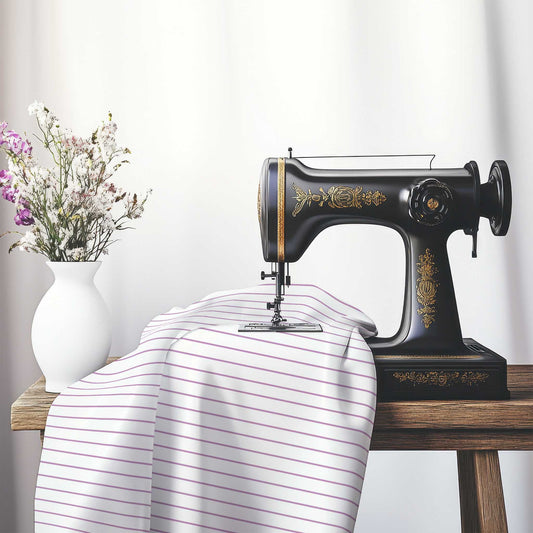 White Spun Polyester Fabric with Fine Mauve Stripes, FASP-1360-151, on an antique sewing machine sitting on a desk with vase of beautiful flowers.