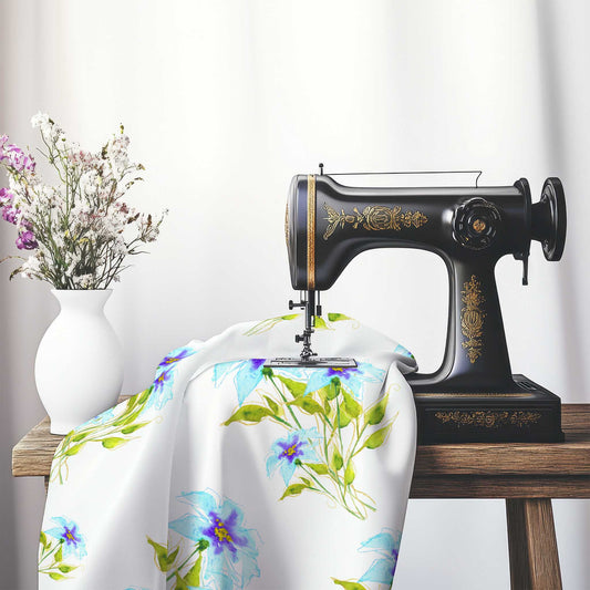 Printed Fabric with Handpainted Blue Watercolor Floral, FASP-1374, on an antique sewing machine sitting on a desk with vase of beautiful flowers.