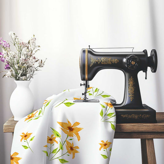 Printed Fabric with Handpainted Yellow-Orange Watercolor Floral, FASP-1394, on an antique sewing machine sitting on a desk with vase of beautiful flowers.