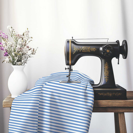 White Spun Polyester Fabric with Thin Blue Bars, FASP-1400-241, on an antique sewing machine sitting on a desk with vase of beautiful flowers.