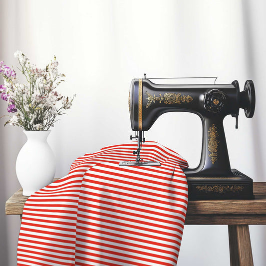 White Spun Polyester Fabric with Thin Red Bars, FASP-1410-241, on an antique sewing machine sitting on a desk with vase of beautiful flowers.