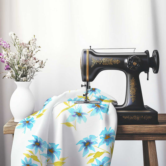 Printed Fabric with Handpainted Blue Watercolor Floral, FASP-1434, on an antique sewing machine sitting on a desk with vase of beautiful flowers.