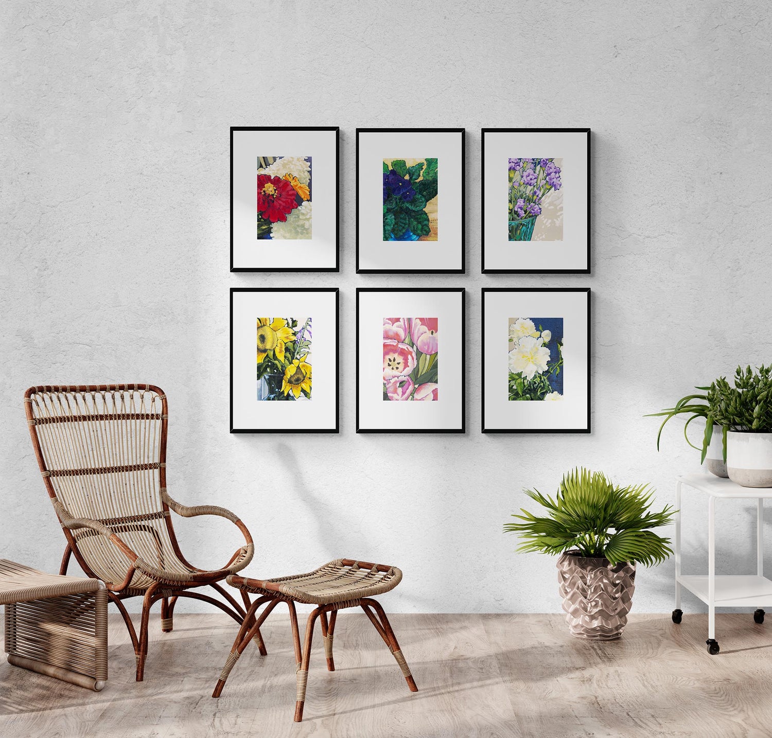 Set of six framed floral prints on a wall with a wicker chair and plants in the foreground.