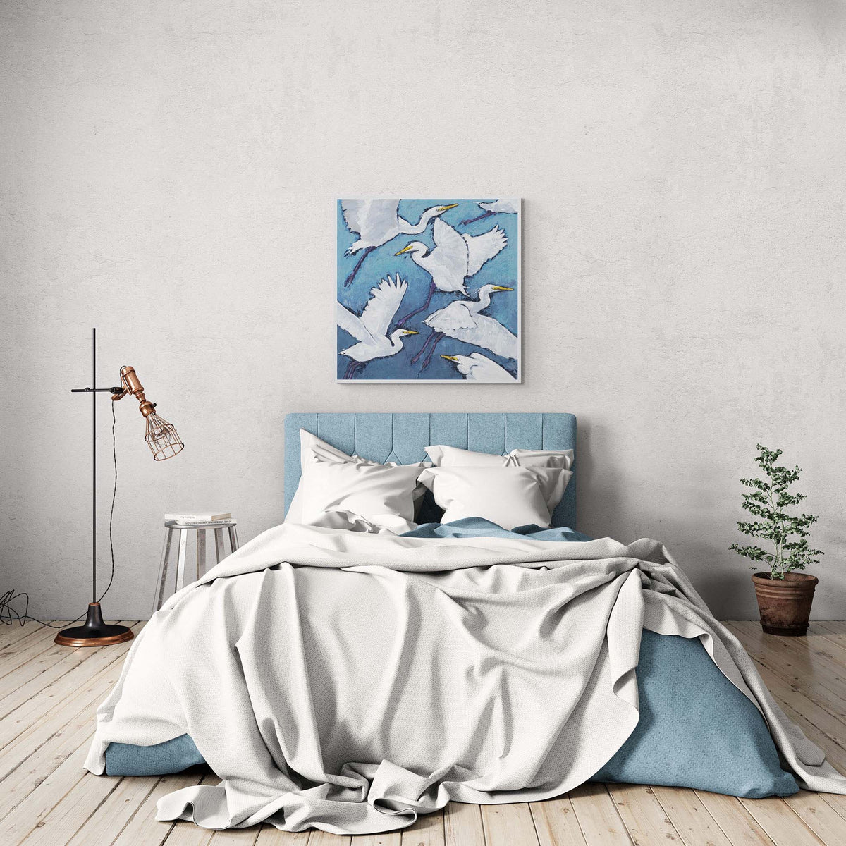White Herons Fine Art Canvas Print | Styled in Rustic Coastal Bedroom with Blue Upholstered Headboard and Hardwood Floors