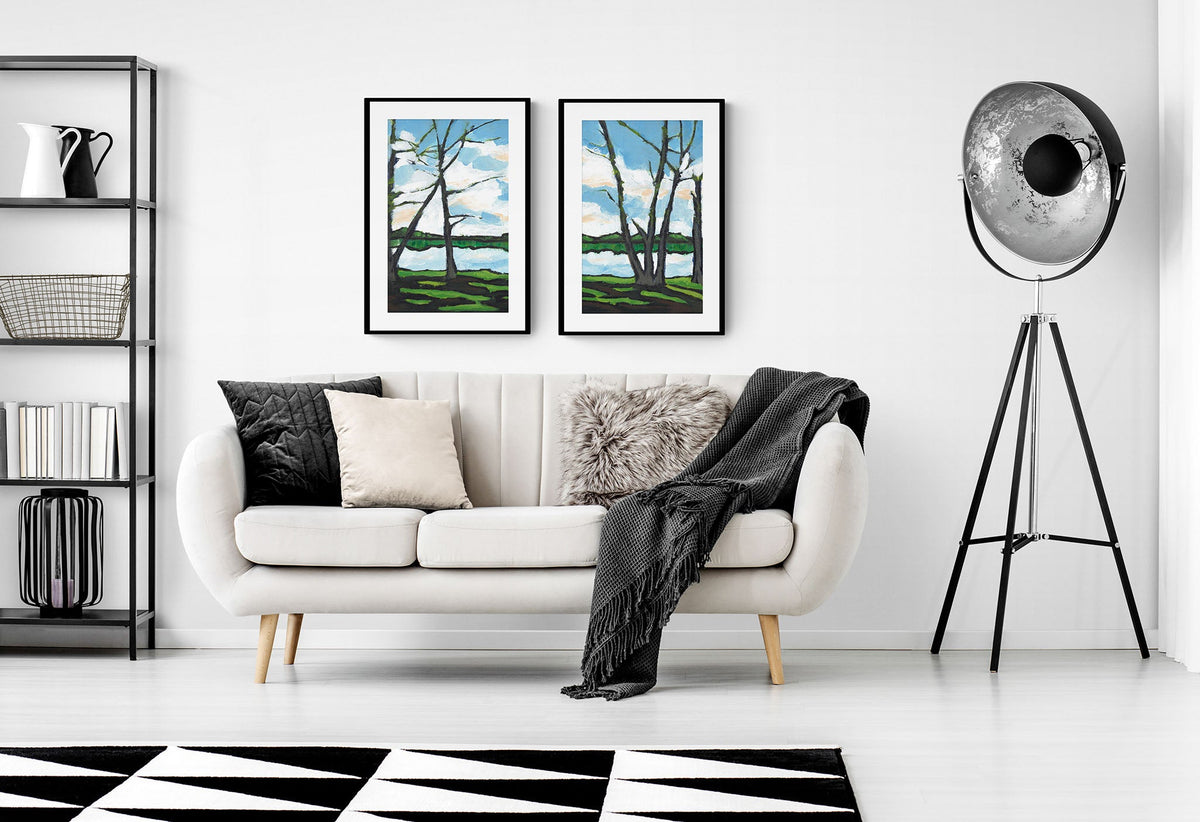 Two Lakeshore Landscape Fine Art Prints | Styled in Bold Monochrome Living Room with Cream Channel-Back Sofa, Black Steel Shelving Unit and Industrial Tripod Spotlight