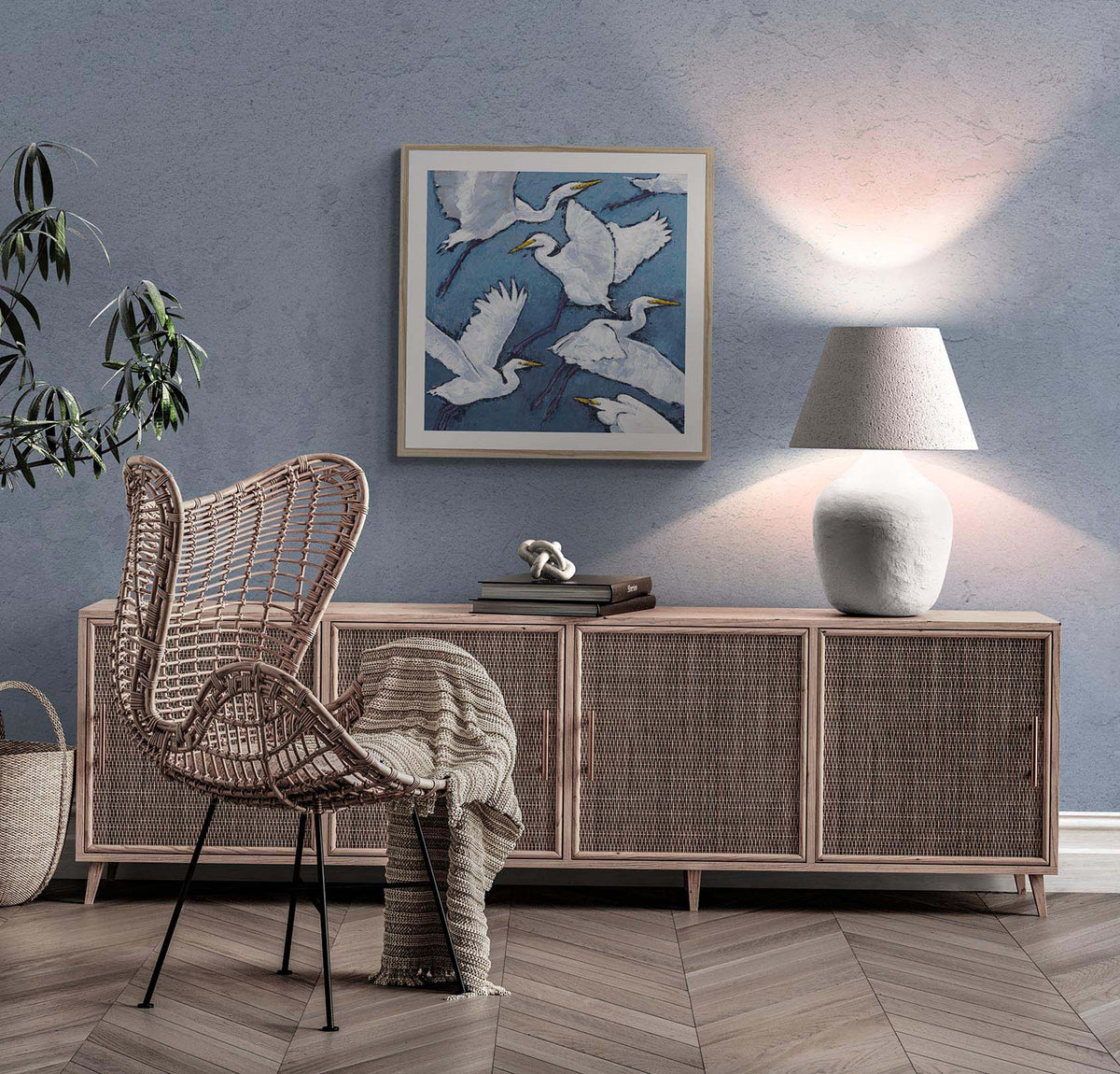 White Herons Fine Art Print | Styled in Serene Coastal Living Room with Rattan Wingback Chair, Whitewashed Cane-Front Credenza, Textured Ceramic Table Lamp and Chevron Parquet Floor